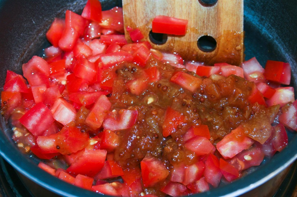 Lightly frying the tomato and chutney