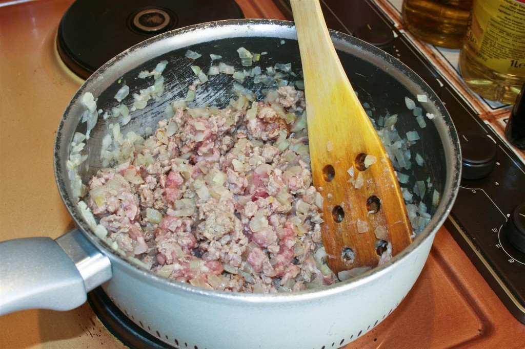Frying the onion with the meat